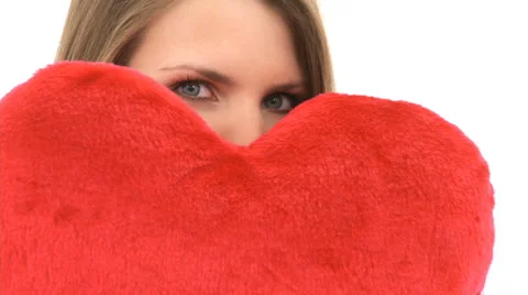 Woman Hides Behind A Heart Pillow