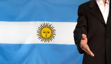 Open hand and Argentina flag in the background