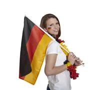 Attractive Woman Shows German Flag And Smiles In Front Of White Background