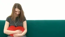 Pretty Woman listening to music and cuddling with a heart pillow