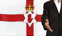 Open hand and Northern Ireland flag in the background