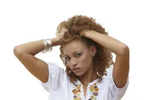 Beautiful woman with her hands in curly hair