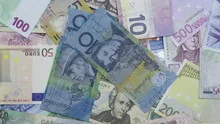 Time lapse zoom out of money piling up