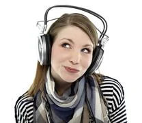 Beautiful Young Smiling Woman Listens To Music With Headphones On Her Head
