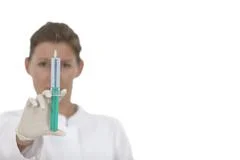 Woman Doctor With Green Syringe On White