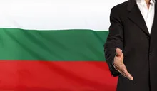 Open hand and Bulgaria flag in the background