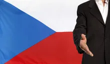 Open hand and Czech Republic flag in the background