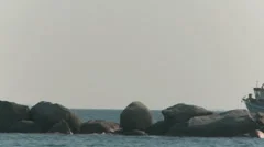 Rocks In The Ocean And A Boat