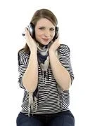 Beautiful Young Smiling Woman Listens To Music With Headphones On Her Head