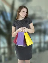 Portrait of young happy smiling woman with shopping bags