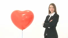 Woman Standing Next To Lifting Heart Balloon