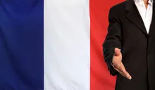Open hand and France flag in the background