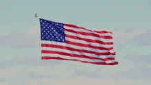 The American flag waving in blue sky
