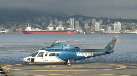 Helicopter Starting On A Platform In The Background Skyline Of North Vancouver 