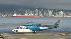 Helicopter Starting On A Platform In The Background Skyline Of North Vancouver 