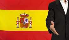 Open hand and Spain flag in the background