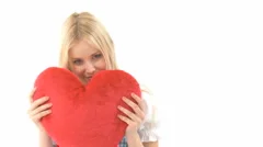 Woman Cuddling With Heart Pillow