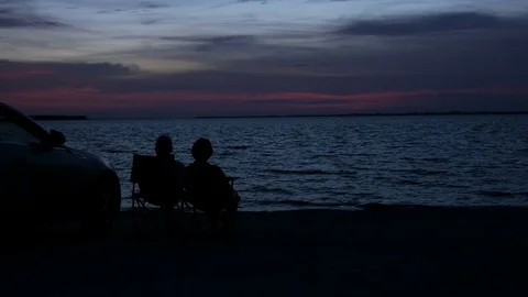Silhouettes Of A Beach Couple At Sunset