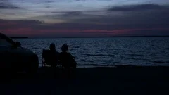 Silhouettes Of A Beach Couple At Sunset