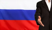 Open hand and Russia flag in the background