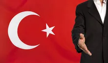 Open hand and Turkey flag in the background