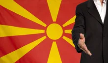 Open hand and Macedonia flag in the background