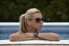 Beautiful Woman In A Swimming Pool During Summer