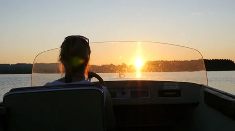 Motorboat Woman Into Sunset