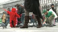 Feeding Pigeons On St. Mark'S Square In Venice