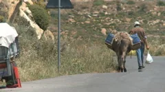 Man Is Walking With His Donkey On The Streets In Naxos, Greece
