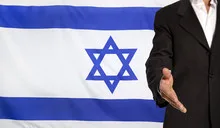 Open hand and Israel flag in the background