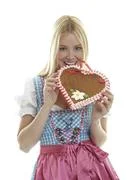 Woman Bites In An Empty German Gingerbread Heart