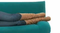 Pan Shot Woman Relaxes On Couch With Music