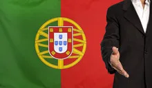 Open hand and Portugal flag in the background