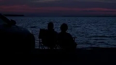 Silhouettes Of A Beach Couple At Twilight