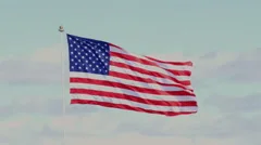 The American Flag Waving In Blue Sky