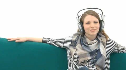 Beautiful Girl Relaxing On The Couch With Music