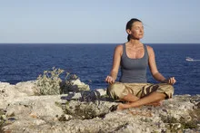 Yoga exercise on a rock