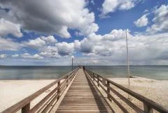 Wooden Pier Over The Baltic Sea With Clouds