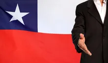 Open hand and Chile flag in the background