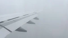Airplane Wings Flying Through Clouds