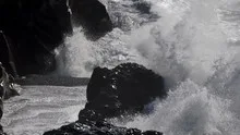 Slowmotion waves crashing on rock coast