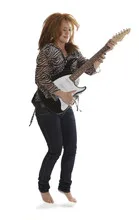 Young rock lady jumping with an electric guitar