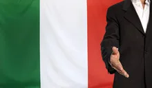 Open hand and Italy flag in the background