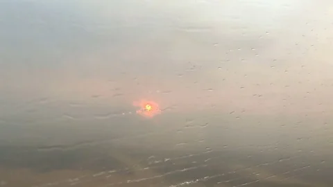 Raindrops On Airplane Window At Sunset