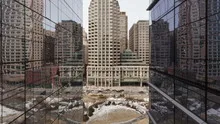 4K Time lapse of traffic on office building reflection