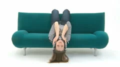 Woman Relaxes On Couch With Music
